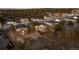 High aerial view of a neighborhood showcasing beautifully landscaped properties nestled among mature trees and natural surroundings at 6001 Powell Rds, Parker, CO 80134