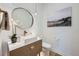 Modern powder room with a square vessel sink and a round mirror at 6001 Powell Rd, Parker, CO 80134