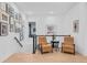 Staircase landing with wood floors, modern furnishings, art display, and natural light from the window at 6001 Powell Rd, Parker, CO 80134
