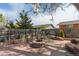 Backyard with a central fire pit area, stone patio, landscaping and wooden fence at 1313 Garden Cir, Longmont, CO 80501