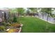 Wide backyard with a lush green lawn, rock gardens, and patio area at 1313 Garden Cir, Longmont, CO 80501
