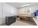 A partially finished basement has shelving, a workbench, and storage space at 1313 Garden Cir, Longmont, CO 80501