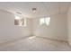 A finished basement boasts two windows and neutral carpeting at 1313 Garden Cir, Longmont, CO 80501