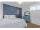 Bedroom with navy accent wall, natural light, and a vintage dresser at 1313 Garden Cir, Longmont, CO 80501