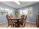 Charming dining area with hardwood floors and abundant natural light from large windows at 1313 Garden Cir, Longmont, CO 80501