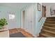 Inviting foyer with hardwood floors, neutral paint, and staircase to the upper level at 1313 Garden Cir, Longmont, CO 80501
