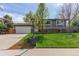 Charming home with a well-maintained lawn and a two-car garage, showcasing curb appeal at 1313 Garden Cir, Longmont, CO 80501