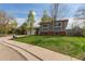 Lovely home with mature trees, showcasing a well-manicured lawn and inviting curb appeal at 1313 Garden Cir, Longmont, CO 80501