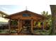 Outdoor structure with bar area, tv, seating, and lush landscaping at 1313 Garden Cir, Longmont, CO 80501