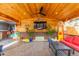 Covered patio area with an outdoor living space, television, and bar at 1313 Garden Cir, Longmont, CO 80501