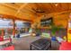 Outdoor patio featuring a gas grill, mounted TV, ceiling fan, and rustic decor at 1313 Garden Cir, Longmont, CO 80501