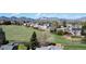A bird's eye view of the neighborhood with grassy fields and distant mountains at 4845 S Taft St, Morrison, CO 80465
