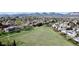 Neighborhood aerial view with a large grassy field and mature trees in the spring at 4845 S Taft St, Morrison, CO 80465