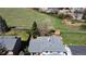 The backyard of the house includes mature trees and backs up to a large grassy area at 4845 S Taft St, Morrison, CO 80465