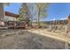 Large backyard with deck, mature trees, fire pit, and space for gardening for relaxing outdoors at 4845 S Taft St, Morrison, CO 80465