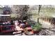 Spacious backyard features mature trees, a deck, stone steps, and space for gardening for relaxing outdoors at 4845 S Taft St, Morrison, CO 80465