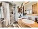 Bathroom featuring a tiled shower and wooden vanity at 4845 S Taft St, Morrison, CO 80465
