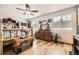 Bright bedroom featuring wood floors, a rustic bed frame, and a decorative dresser at 4845 S Taft St, Morrison, CO 80465