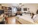 Cozy bedroom featuring hardwood floors, built-in bookshelves, and a decorative ceiling fan with comforting natural light at 4845 S Taft St, Morrison, CO 80465