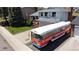 Two-story home with a large bus parked in front, green lawn, and well-maintained landscaping at 4845 S Taft St, Morrison, CO 80465