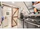 Functional laundry room featuring new front load machines, shiplap barn door, and utility sink at 4845 S Taft St, Morrison, CO 80465