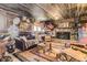 Eclectic living room featuring rustic wood walls, stone fireplace, and vintage decor at 4845 S Taft St, Morrison, CO 80465