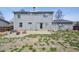 Spacious backyard featuring a stone patio, a cozy seating area, and ample space for outdoor activities at 3660 S Ouray Cir, Aurora, CO 80013
