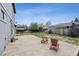 Backyard with a stone patio and lawn, perfect for entertaining at 3660 S Ouray Cir, Aurora, CO 80013