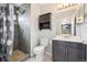 Updated bathroom featuring a gray tile shower, decorative tile accents, and updated fixtures at 3660 S Ouray Cir, Aurora, CO 80013
