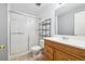 Bathroom featuring a glass shower, wooden vanity, and tile floor at 3660 S Ouray Cir, Aurora, CO 80013