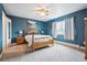 This bedroom features beautiful blue walls, carpeted floor, and a ceiling fan at 3660 S Ouray Cir, Aurora, CO 80013