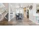 Bright dining room with a ceiling fan, wood floors, and a staircase adjacent to dining area at 3660 S Ouray Cir, Aurora, CO 80013