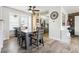 Dining room with a gray wood table, wood floors, a ceiling fan and natural light from large windows at 3660 S Ouray Cir, Aurora, CO 80013