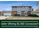 Charming two-story home with a brick facade, gray siding, and an attached two-car garage at 3660 S Ouray Cir, Aurora, CO 80013
