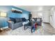 Living room with two gray sofas, black coffee table, a blue accent wall, and neutral rug, creating a relaxing area at 3660 S Ouray Cir, Aurora, CO 80013