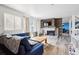 Inviting living room features wood floors, wood accent wall, brick fireplace and sliding glass doors at 3660 S Ouray Cir, Aurora, CO 80013