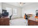 Spacious home office with large windows, two desks, and comfortable chairs at 3660 S Ouray Cir, Aurora, CO 80013