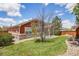 Expansive backyard featuring mature landscaping, lush green grass, and privacy fence at 464 N Jamestown Way, Aurora, CO 80018