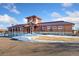 Community clubhouse featuring brick construction and manicured landscaping with snow on the ground at 464 N Jamestown Way, Aurora, CO 80018