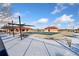 Winter view of the community pool, covered, with snow and the clubhouse in the background at 464 N Jamestown Way, Aurora, CO 80018