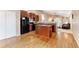 Modern kitchen with wood floors, center island, and stainless-steel appliances at 464 N Jamestown Way, Aurora, CO 80018