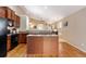 Kitchen features wood floors, island, black appliances, and an open floorplan at 464 N Jamestown Way, Aurora, CO 80018