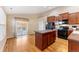Eat-in kitchen with island, black appliances, wood floors and backyard access at 464 N Jamestown Way, Aurora, CO 80018