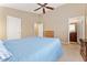 A primary bedroom featuring a fan, closet, and attached bathroom creating a comfortable retreat at 464 N Jamestown Way, Aurora, CO 80018