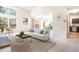 Cozy living room featuring neutral tones, large windows, and a connected dining area at 1566 S Syracuse St, Denver, CO 80231