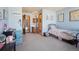 A spacious bedroom with an attached bathroom, carpet, and light blue walls at 2991 W 81St Ave # G, Westminster, CO 80031
