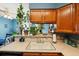 Well-lit kitchen with wood cabinets, a double sink, and a view of the backyard at 2991 W 81St Ave # G, Westminster, CO 80031