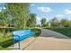 Inviting blue park bench near a walking path surrounded by mature trees at 2991 W 81St Ave # G, Westminster, CO 80031