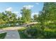 Peaceful pond view with a walking path, bridge and lush foliage at 2991 W 81St Ave # G, Westminster, CO 80031