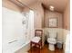 The bathroom is compact with wallpaper, wainscoting, and a white tub and toilet at 200 Rose St, Georgetown, CO 80444